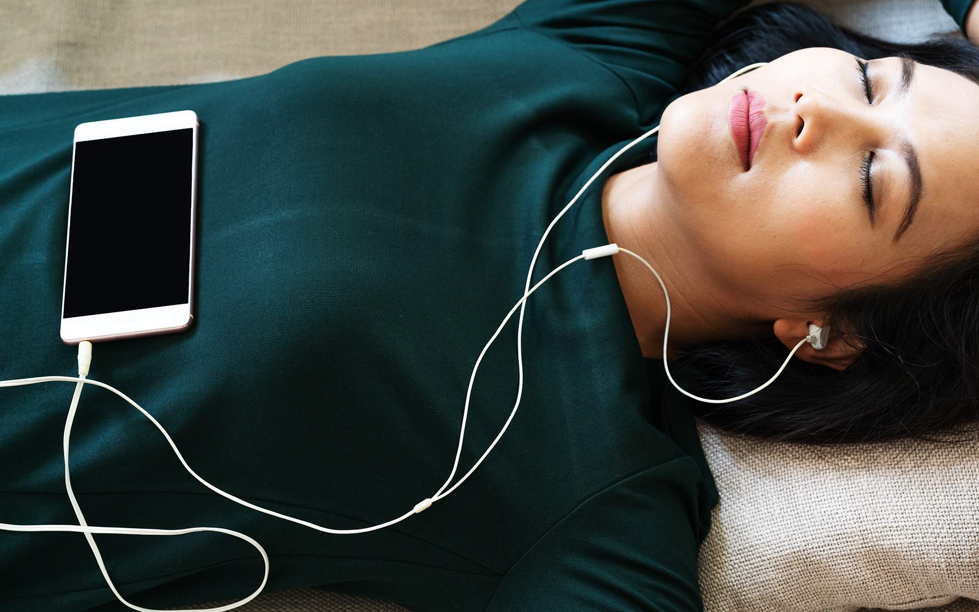 10-Minute Full Body Scan - Over head view of beautiful young woman laying down on sofa usin
