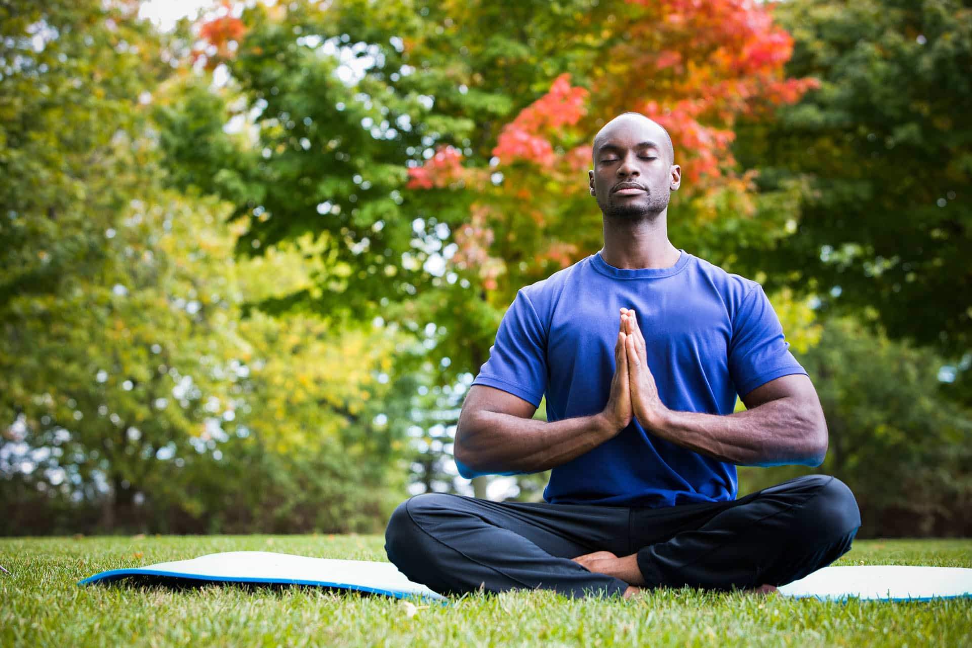 Man practicing mindfulness meditation in a park